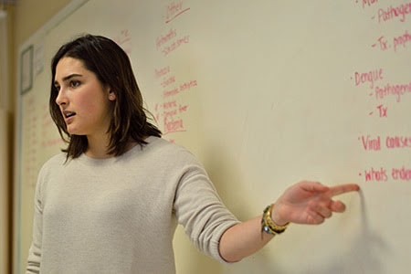 Another person pointing to a whiteboard